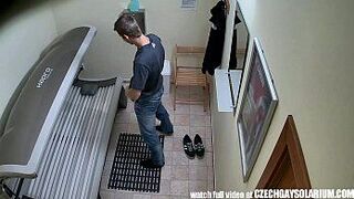 Young man secretly filmed in public solarium - porn video